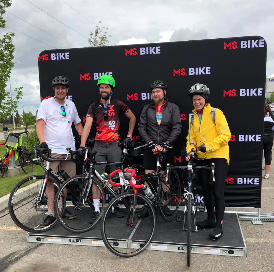 Cory at an MS Bike Tour community event, with fellow riders.